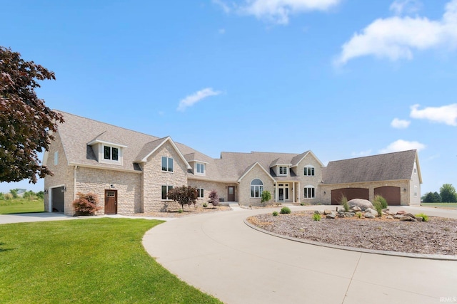 3631 E Pierceton Rd, Warsaw, IN 46580 - view of front of house with concrete driveway, stone siding, a front yard, and a shingled roof