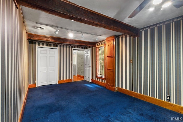3911 Kings Ridge Rd, Mitchell, IN 47446 - below grade area with a ceiling fan, wallpapered walls, dark colored carpet, and track lighting