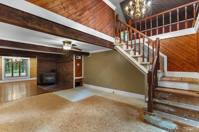 3911 Kings Ridge Rd, Mitchell, IN 47446 - unfurnished living room with a chandelier, stairway, a wood stove, beam ceiling, and wooden walls