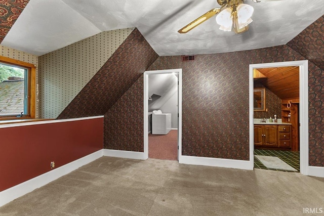 3911 Kings Ridge Rd, Mitchell, IN 47446 - additional living space with vaulted ceiling, wallpapered walls, carpet flooring, and a ceiling fan