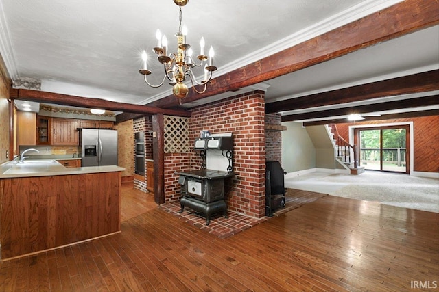 3911 Kings Ridge Rd, Mitchell, IN 47446 - unfurnished living room with a wood stove, stairs, hardwood / wood-style floors, a chandelier, and beam ceiling