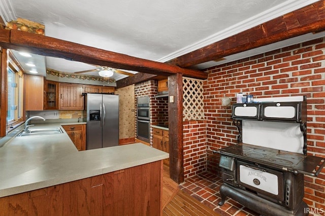 3911 Kings Ridge Rd, Mitchell, IN 47446 - kitchen featuring stainless steel appliances, brown cabinets, beam ceiling, dark wood finished floors, and glass insert cabinets