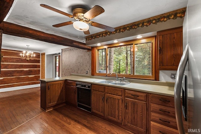 3911 Kings Ridge Rd, Mitchell, IN 47446 - kitchen with stainless steel fridge, black dishwasher, dark wood finished floors, a peninsula, and healthy amount of natural light
