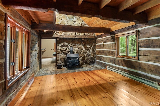 3911 Kings Ridge Rd, Mitchell, IN 47446 - unfurnished living room featuring a wood stove, wood-type flooring, a baseboard heating unit, wood walls, and a wooden ceiling with exposed beams