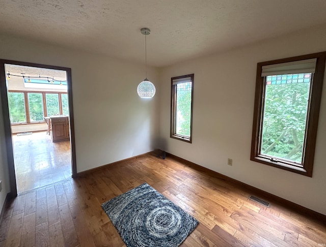 3108 E Charles Ct, Bloomington, IN 47401 - empty room featuring hardwood / wood-style flooring and a textured ceiling
