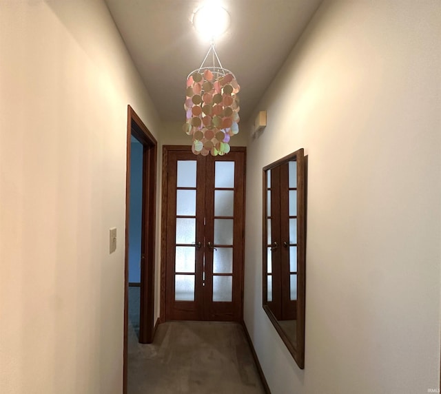 3108 E Charles Ct, Bloomington, IN 47401 - hallway with french doors, carpet floors, and a chandelier