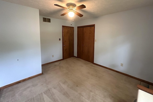 3108 E Charles Ct, Bloomington, IN 47401 - unfurnished bedroom with a textured ceiling, light carpet, and a ceiling fan
