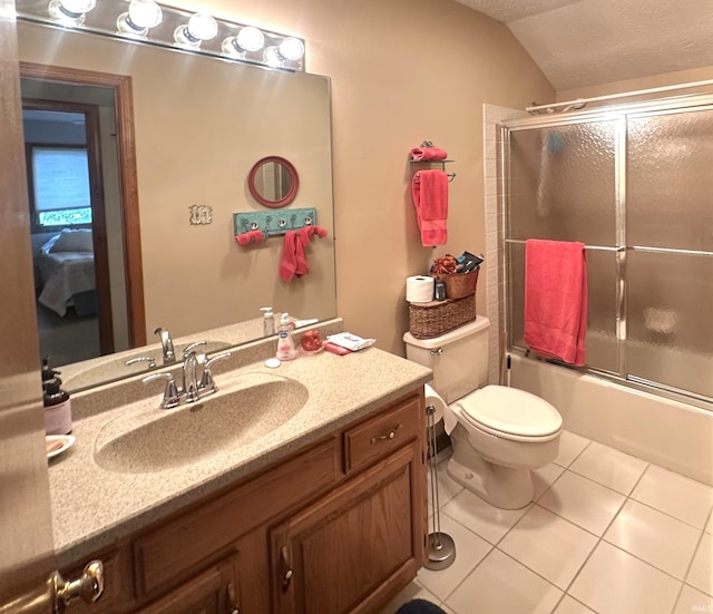 3108 E Charles Ct, Bloomington, IN 47401 - full bathroom with tile patterned flooring, vanity, shower / bath combination with glass door, and vaulted ceiling