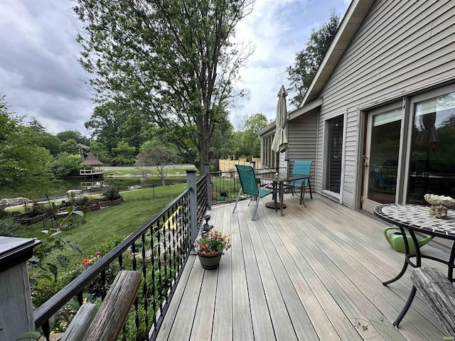 3108 E Charles Ct, Bloomington, IN 47401 - wooden deck featuring outdoor dining area and a yard