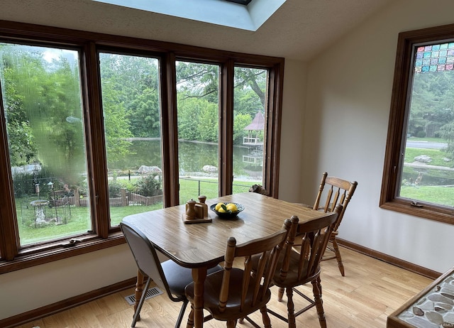 3108 E Charles Ct, Bloomington, IN 47401 - dining area featuring light wood finished floors and vaulted ceiling