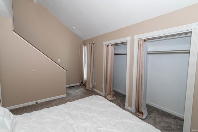 18199 Stoneridge St Apt A, South Bend, IN 46637 - bedroom with carpet flooring, vaulted ceiling, and two closets