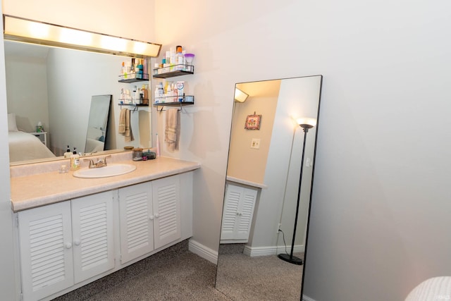 18199 Stoneridge St Apt A, South Bend, IN 46637 - bathroom with vanity and baseboards