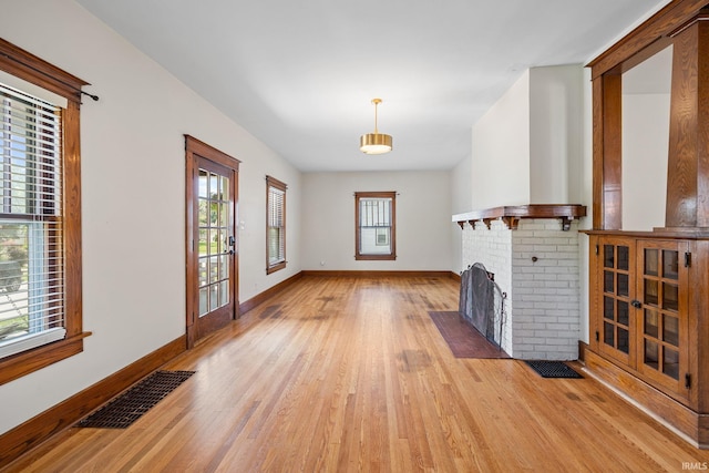 1028 Highland Ave, Lafayette, IN 47905 - unfurnished living room featuring light wood-style flooring and a fireplace
