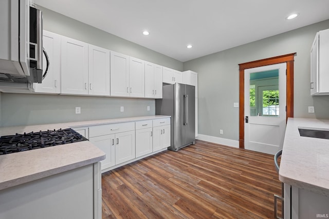 1028 Highland Ave, Lafayette, IN 47905 - kitchen with high end refrigerator, dark wood-style flooring, white cabinets, and recessed lighting