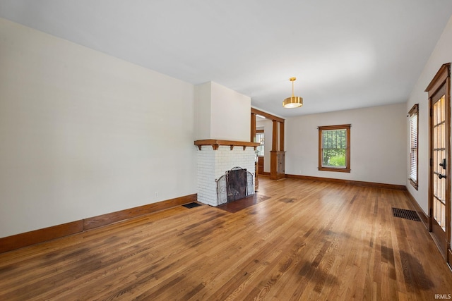 1028 Highland Ave, Lafayette, IN 47905 - unfurnished living room featuring wood finished floors and a fireplace