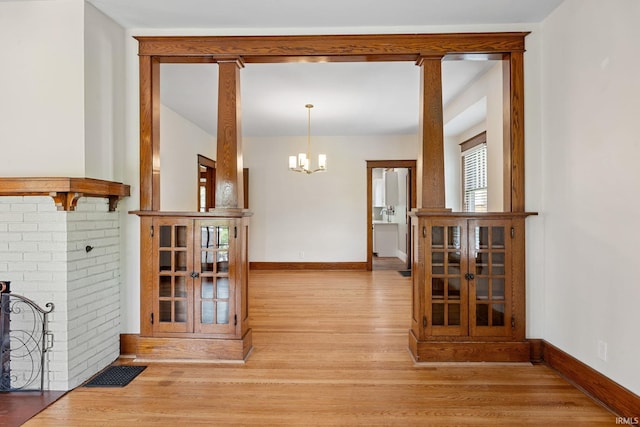 1028 Highland Ave, Lafayette, IN 47905 - corridor with wood finished floors and a chandelier