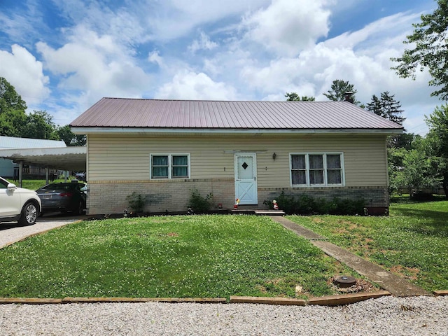 273 W Faculty St, Paoli, IN 47454 - view of front of property with brick siding, a front yard, and a carport