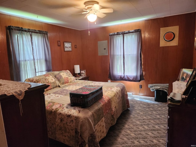 273 W Faculty St, Paoli, IN 47454 - bedroom featuring multiple windows, carpet floors, wooden walls, a ceiling fan, and electric panel