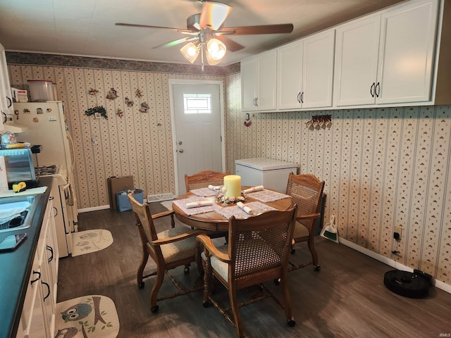 273 W Faculty St, Paoli, IN 47454 - dining room with dark wood-style flooring, wallpapered walls, and ceiling fan