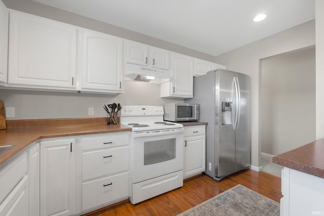 7070 Desdemona Xing, Fort Wayne, IN 46818 - kitchen featuring white electric range oven, under cabinet range hood, stainless steel fridge, white cabinetry, and recessed lighting