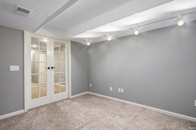 14341 Teal Ct, Granger, IN 46530 - carpeted spare room with french doors, rail lighting, and a textured ceiling