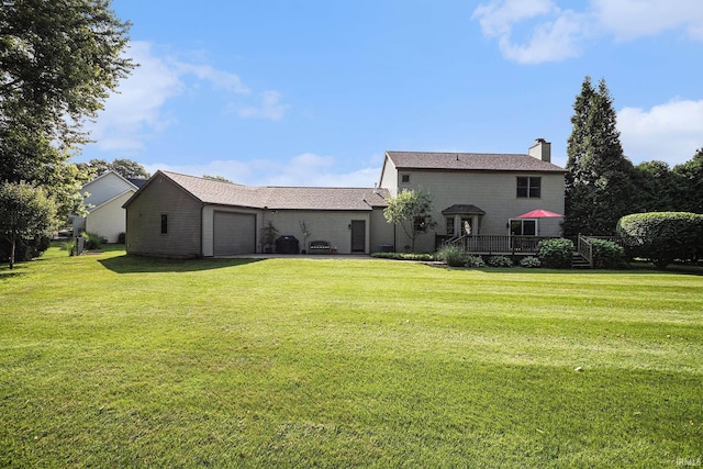 14341 Teal Ct, Granger, IN 46530 - rear view of property featuring a garage, a yard, a chimney, and a wooden deck