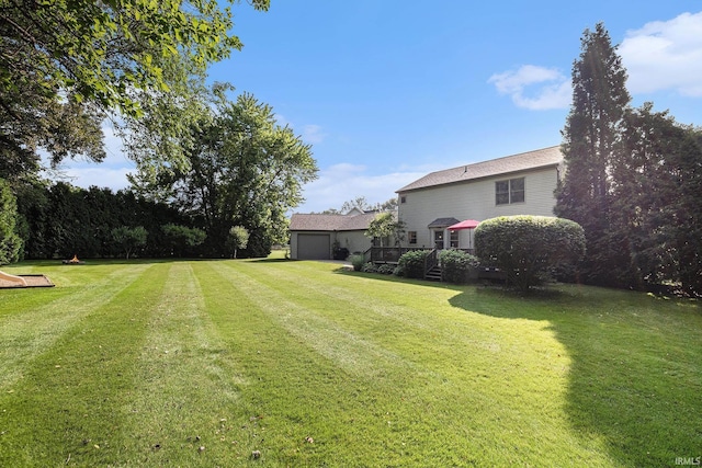 14341 Teal Ct, Granger, IN 46530 - view of green lawn with a wooden deck and an attached garage