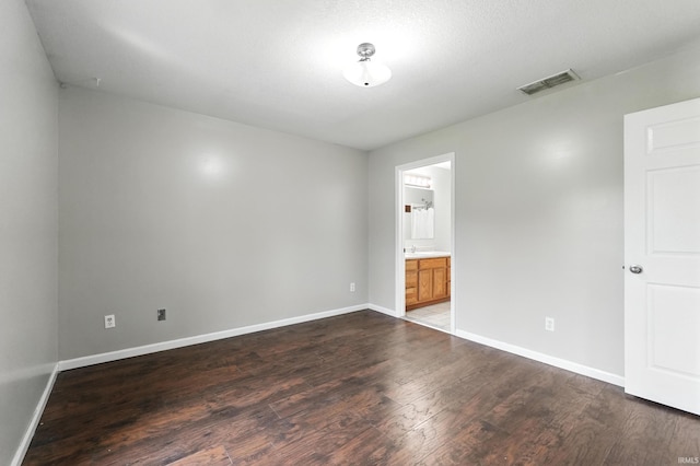 2005 Priscilla Ln, Kendallville, IN 46755 - unfurnished bedroom featuring dark wood-style flooring and connected bathroom
