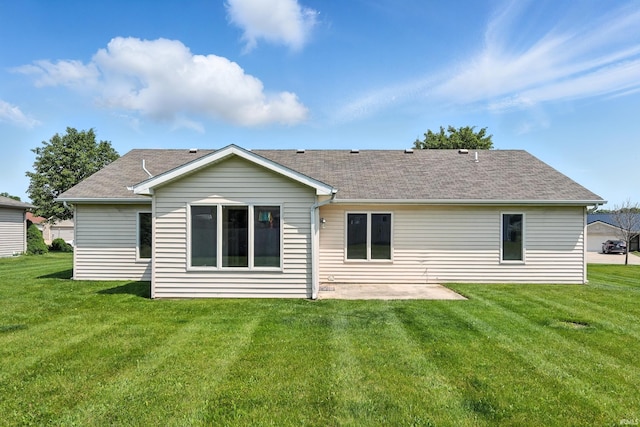 2005 Priscilla Ln, Kendallville, IN 46755 - back of property featuring a patio, a lawn, and roof with shingles