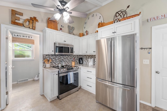 1308 N Buckeye Rd, Muncie, IN 47304 - kitchen with appliances with stainless steel finishes, backsplash, light countertops, white cabinets, and ceiling fan