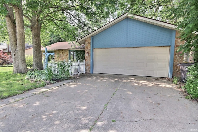8426 Creekside Pl, Fort Wayne, IN 46804 - view of front of property with stone siding, concrete driveway, and an attached garage