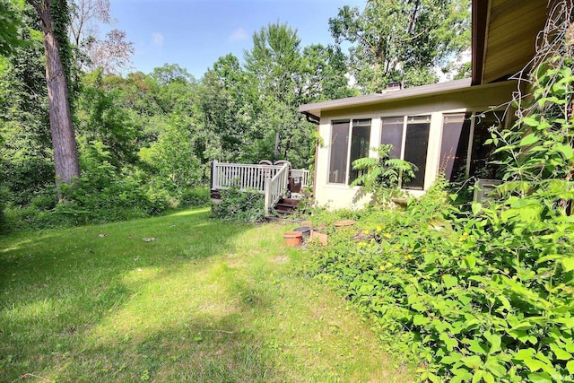 8426 Creekside Pl, Fort Wayne, IN 46804 - view of green lawn featuring a sunroom and a wooden deck