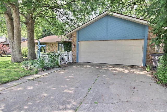8426 Creekside Pl, Fort Wayne, IN 46804 - view of front facade with stone siding, concrete driveway, and an attached garage