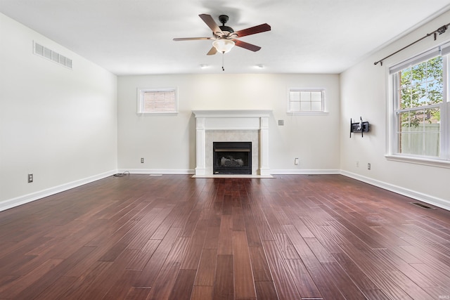 3746 Rolling Rock Dr, Evansville, IN 47711 - unfurnished living room with ceiling fan, a tiled fireplace, and dark wood-type flooring