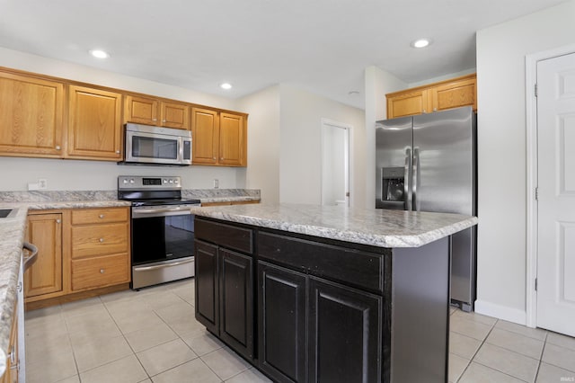 3746 Rolling Rock Dr, Evansville, IN 47711 - kitchen with appliances with stainless steel finishes, light tile patterned flooring, dark cabinets, a kitchen island, and recessed lighting