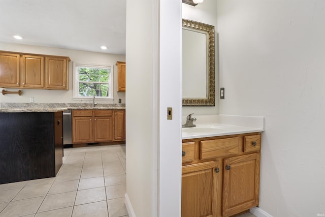 3746 Rolling Rock Dr, Evansville, IN 47711 - kitchen with stainless steel dishwasher, light tile patterned floors, brown cabinetry, and recessed lighting
