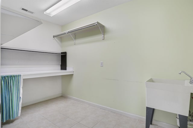3746 Rolling Rock Dr, Evansville, IN 47711 - laundry room with baseboards and tile patterned flooring