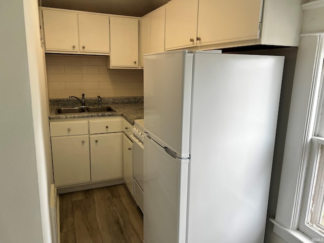 1026 E Wayne St, South Bend, IN 46617 - kitchen with white appliances, backsplash, wood finished floors, and white cabinets