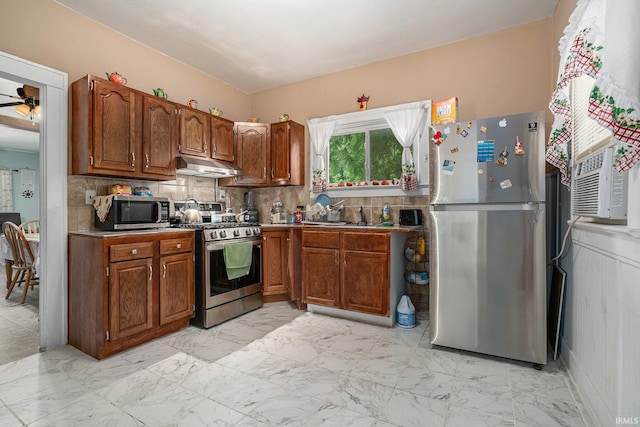 405 Middlebury St, Goshen, IN 46528 - kitchen featuring appliances with stainless steel finishes, under cabinet range hood, decorative backsplash, and light marble finish flooring