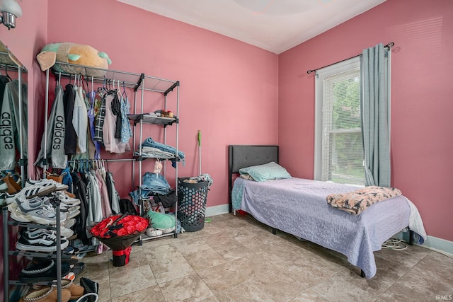 405 Middlebury St, Goshen, IN 46528 - bedroom featuring baseboards and stone finish floors