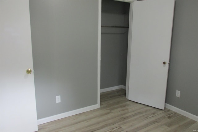 907 S Tennessee, Muncie, IN 47302 - unfurnished bedroom with light wood-type flooring and a closet