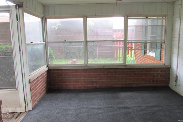 907 S Tennessee, Muncie, IN 47302 - unfurnished sunroom with carpet flooring and brick wall