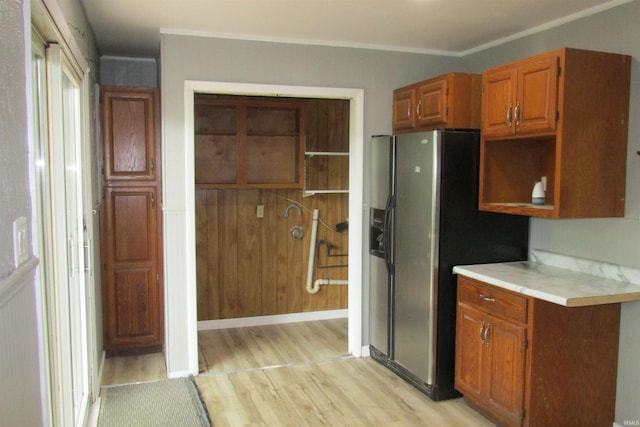 907 S Tennessee, Muncie, IN 47302 - kitchen with open shelves, light wood finished floors, stainless steel fridge, light countertops, and brown cabinetry