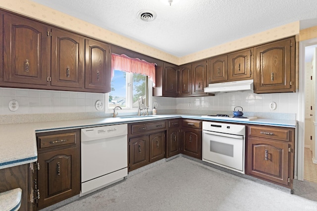 16801 Darling Rd, Woodburn, IN 46797 - kitchen featuring white appliances, under cabinet range hood, a textured ceiling, light countertops, and backsplash