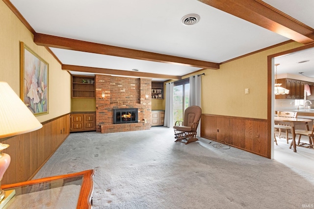 16801 Darling Rd, Woodburn, IN 46797 - unfurnished living room with a wainscoted wall, wooden walls, beamed ceiling, carpet floors, and a brick fireplace