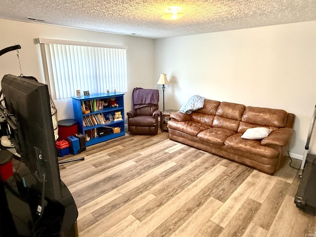 5918 S Foxwood Ln, Bloomington, IN 47401 - living room featuring wood finished floors and a textured ceiling