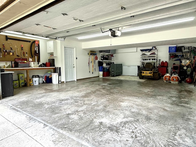 5918 S Foxwood Ln, Bloomington, IN 47401 - garage with a garage door opener and a workshop area