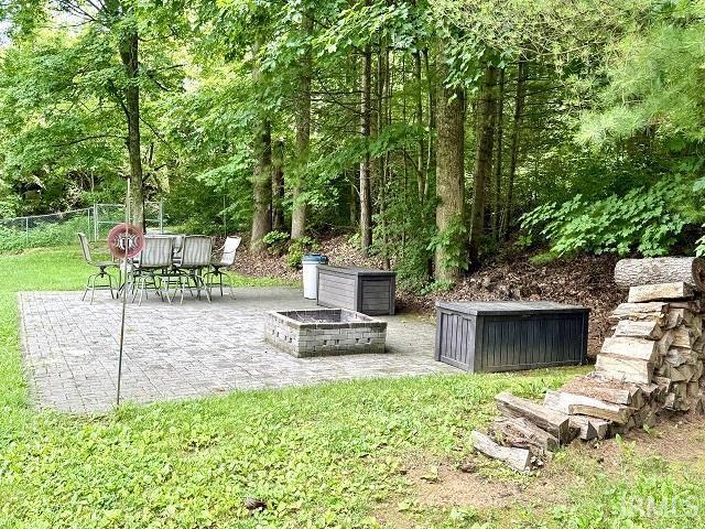 5918 S Foxwood Ln, Bloomington, IN 47401 - view of yard with a patio area and a fire pit