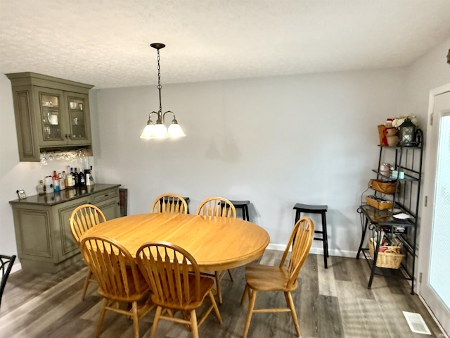 5918 S Foxwood Ln, Bloomington, IN 47401 - dining space featuring dark wood-style floors and a chandelier