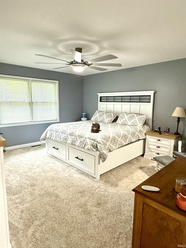 5918 S Foxwood Ln, Bloomington, IN 47401 - bedroom with light colored carpet and a ceiling fan